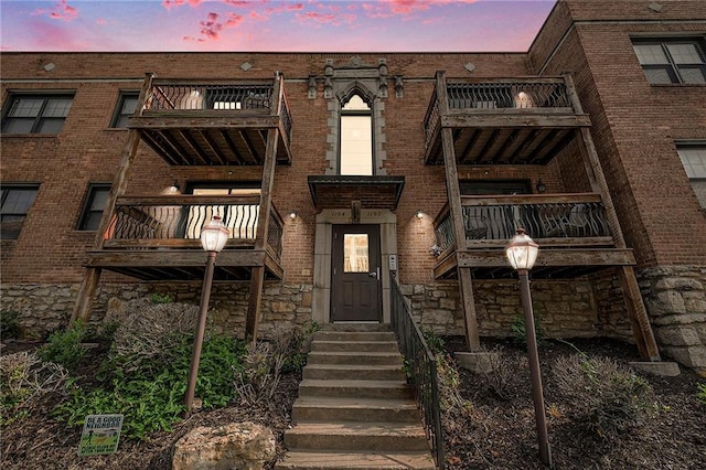 1102 W 46th St Unit 3, Kansas City, MO 64111 - view of front of property with a balcony, stone siding, and brick siding