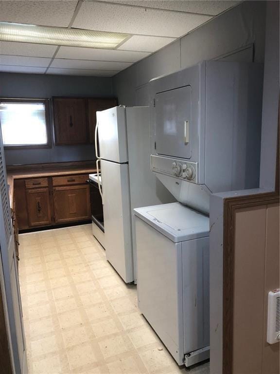 kitchen with a paneled ceiling and white appliances