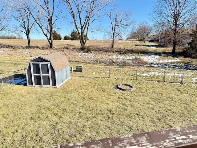 view of yard with a rural view and a storage shed