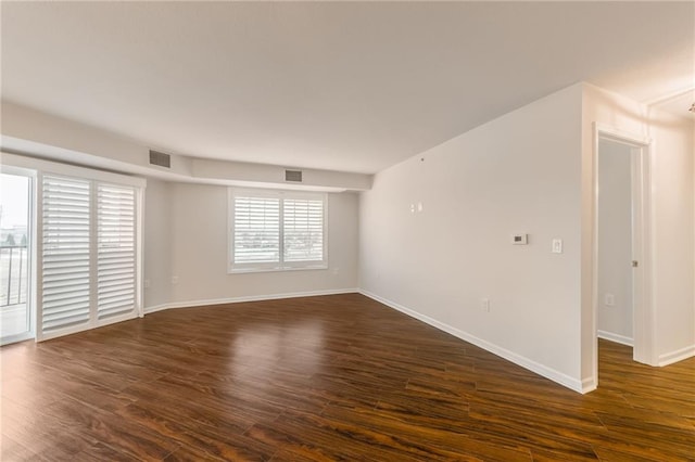 spare room featuring dark hardwood / wood-style floors