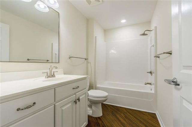 full bathroom featuring vanity, wood-type flooring, shower / washtub combination, and toilet