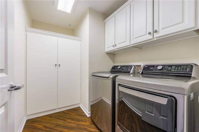 laundry area with separate washer and dryer, dark hardwood / wood-style flooring, and cabinets