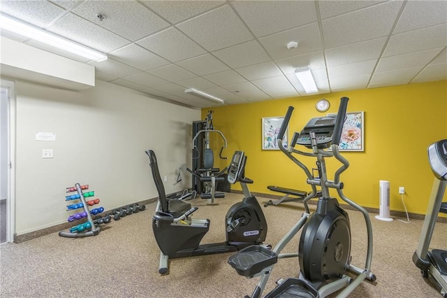 workout room with a drop ceiling and carpet