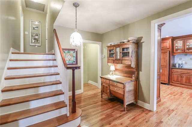 staircase with hardwood / wood-style floors