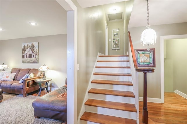 stairway with hardwood / wood-style floors