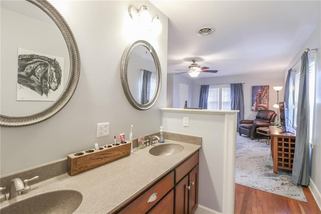 bathroom featuring hardwood / wood-style flooring, ceiling fan, and vanity