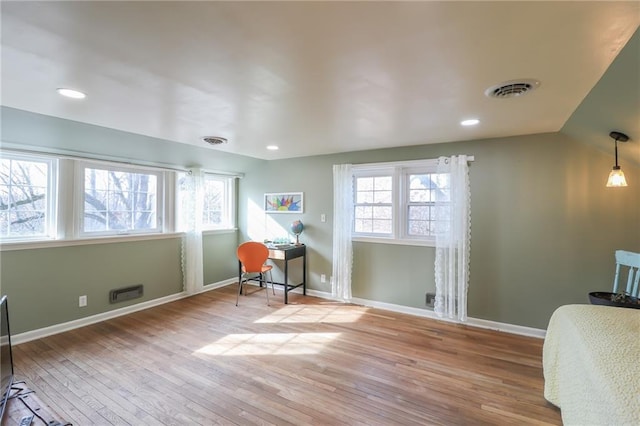 home office featuring lofted ceiling and light hardwood / wood-style floors