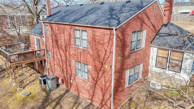 view of side of home featuring a wooden deck and central AC unit