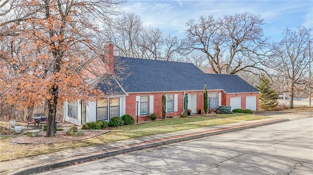 view of front of house featuring a garage and a front lawn