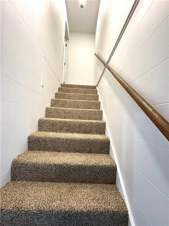 stairway with tile walls