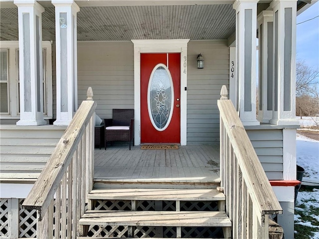 view of exterior entry with a porch