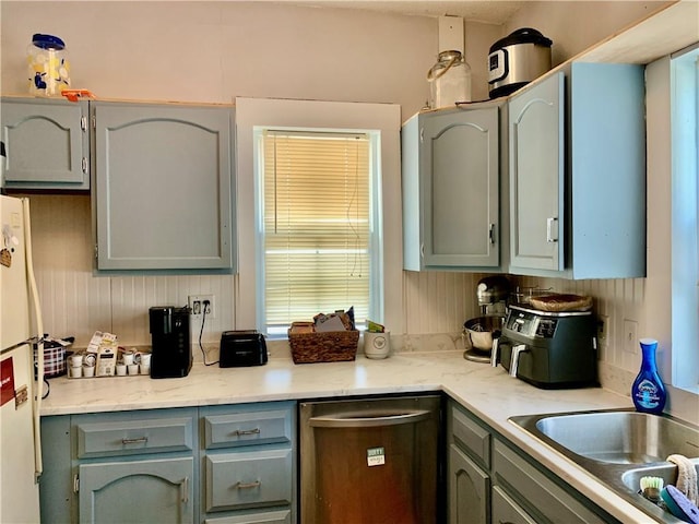 kitchen with sink, dishwasher, and white refrigerator