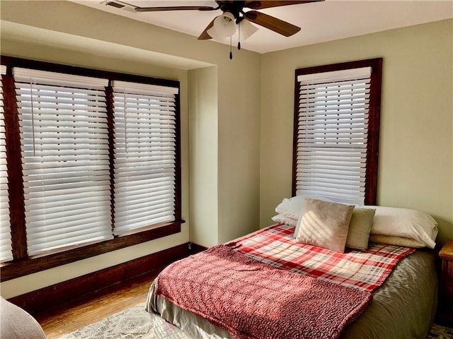 bedroom with wood-type flooring and ceiling fan