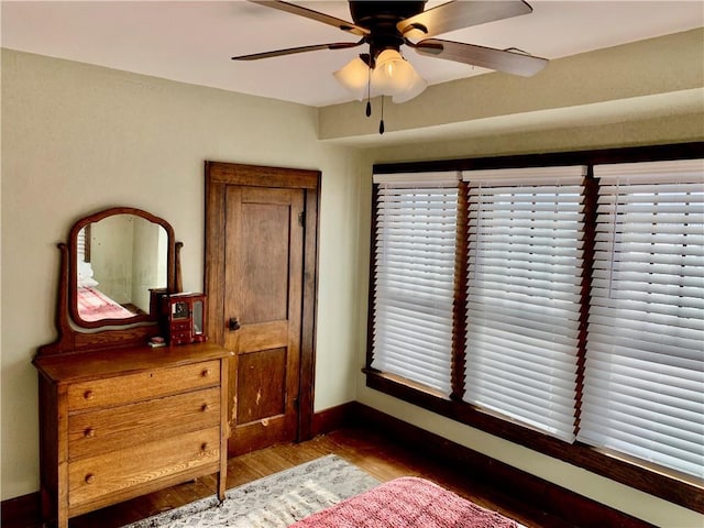 bedroom featuring dark wood-type flooring and ceiling fan