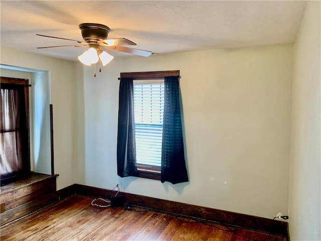 unfurnished room with ceiling fan and hardwood / wood-style floors