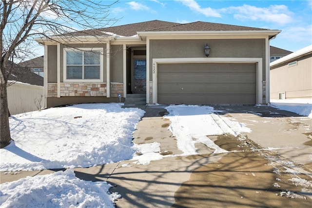 view of front of home featuring stone siding, fence, an attached garage, and stucco siding