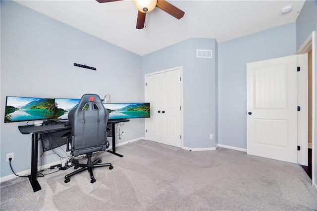 office area featuring a ceiling fan, visible vents, light carpet, and baseboards