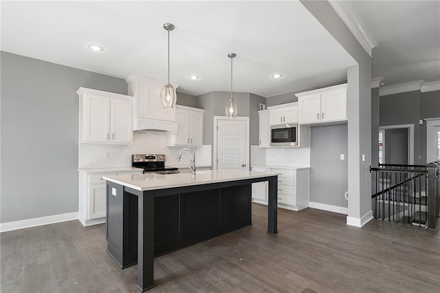 kitchen with built in microwave, an island with sink, white cabinets, and stainless steel range with electric cooktop