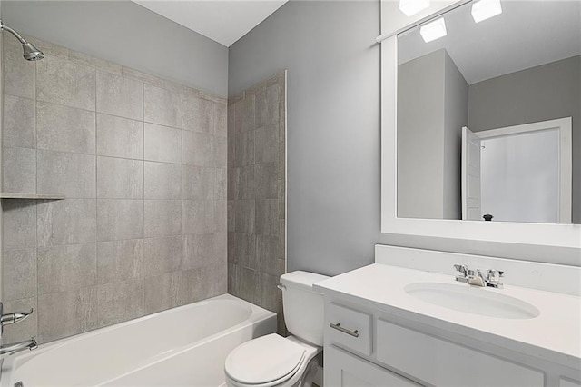 full bathroom featuring vanity, toilet, and tiled shower / bath