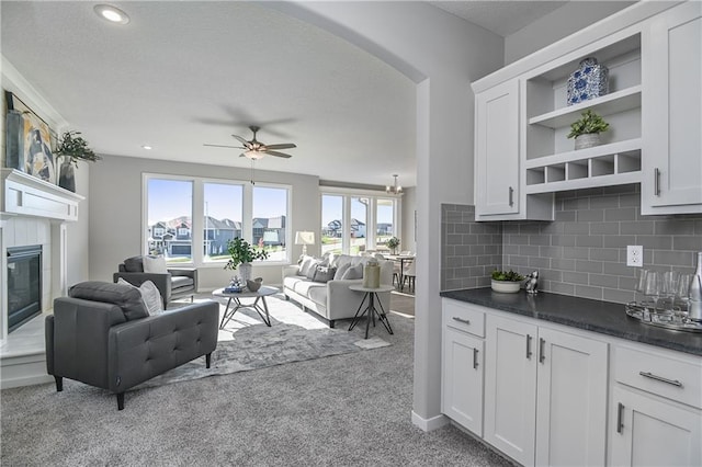 living room with light colored carpet and ceiling fan