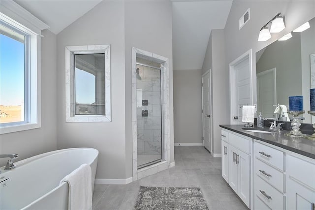 bathroom featuring tile patterned floors, lofted ceiling, plus walk in shower, and vanity