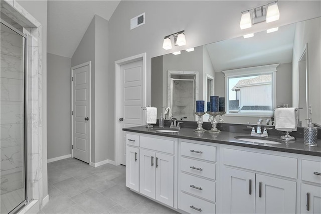 bathroom featuring vaulted ceiling, an enclosed shower, and vanity