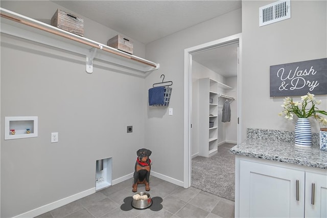 clothes washing area with light tile patterned flooring, hookup for a washing machine, and electric dryer hookup