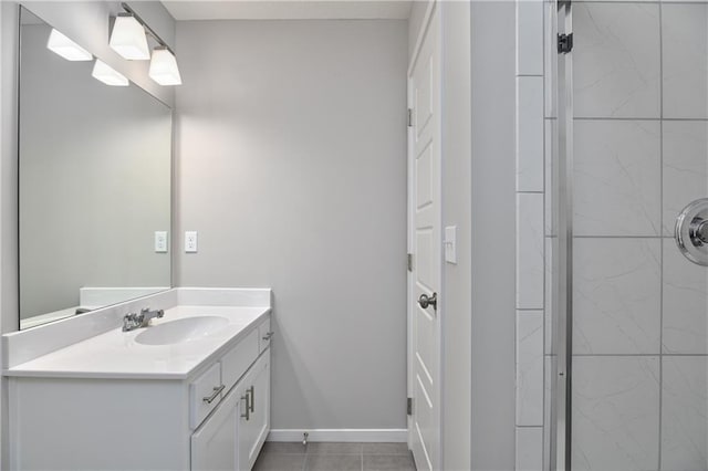 bathroom featuring vanity, tile patterned floors, and a tile shower