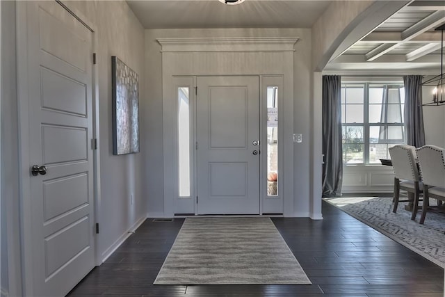 entryway with beamed ceiling and dark hardwood / wood-style flooring