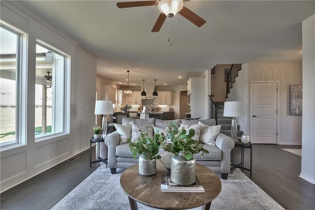 living room with dark hardwood / wood-style floors and ceiling fan