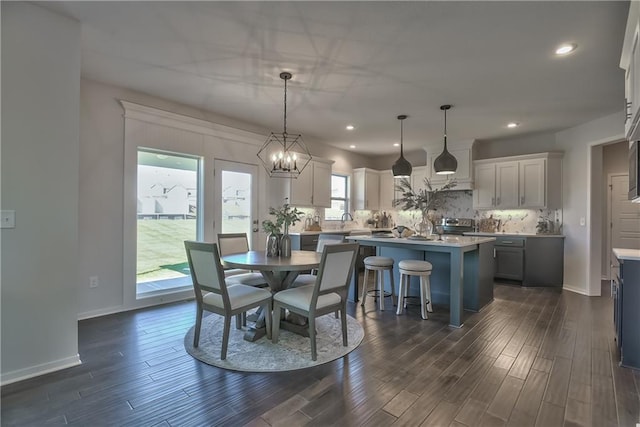 dining area with dark wood-type flooring and plenty of natural light