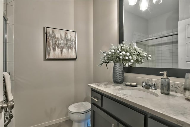 bathroom featuring walk in shower, vanity, and toilet