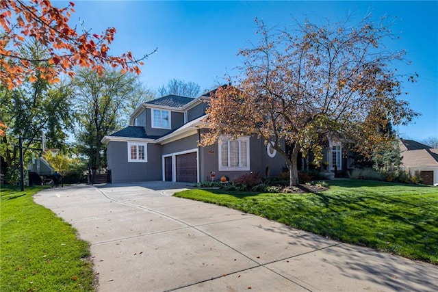 view of front of property featuring a front yard and a garage