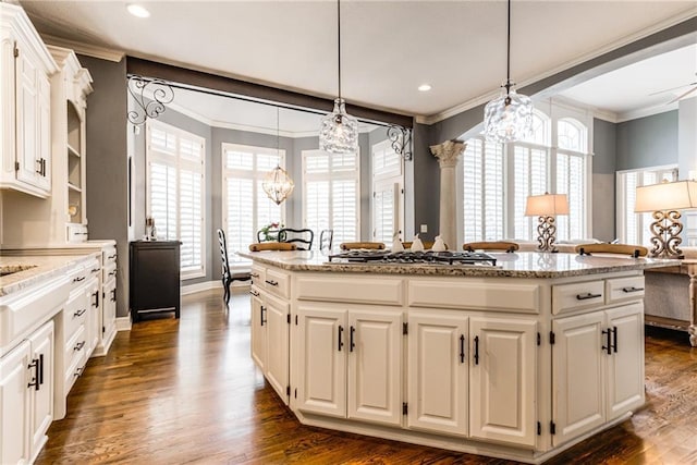 kitchen featuring white cabinets, pendant lighting, a center island, and stainless steel gas cooktop