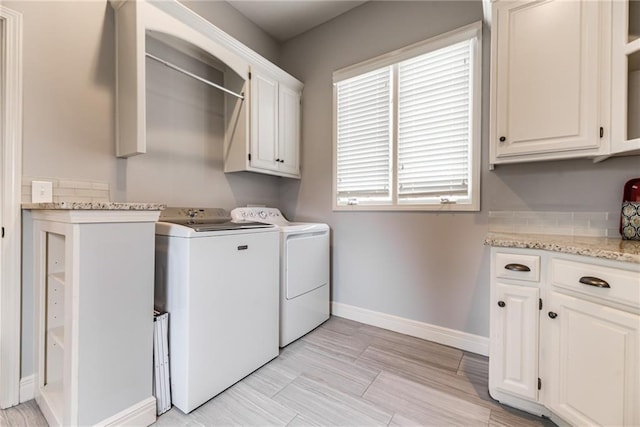 laundry room featuring cabinets and washing machine and dryer