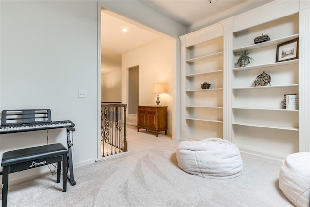 sitting room featuring light colored carpet