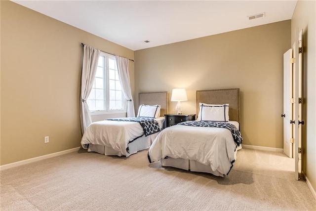 bedroom with light colored carpet