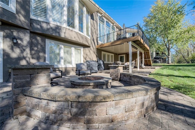 view of patio / terrace featuring a grill and an outdoor fire pit