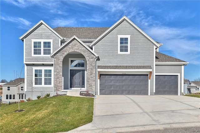 view of front of home with a garage and a front lawn