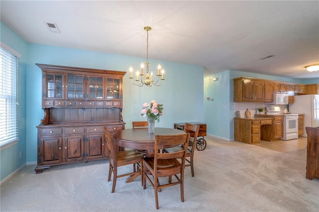 dining area with a healthy amount of sunlight, light carpet, and visible vents