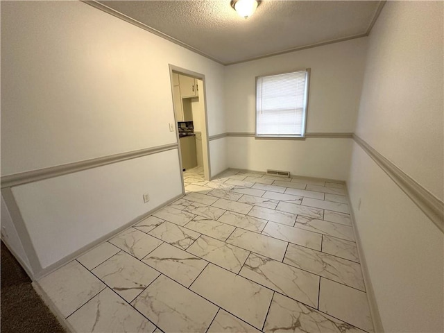 spare room with a textured ceiling