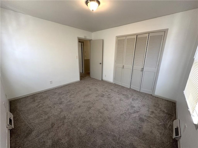 unfurnished bedroom featuring carpet flooring and a closet