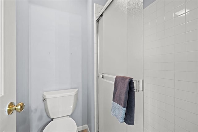 bathroom with an enclosed shower and toilet