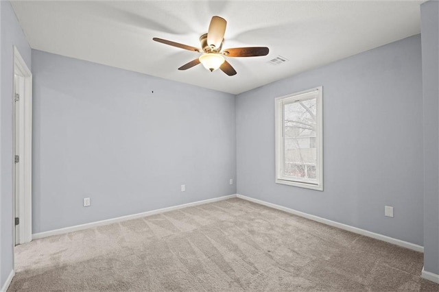 empty room with light colored carpet and ceiling fan