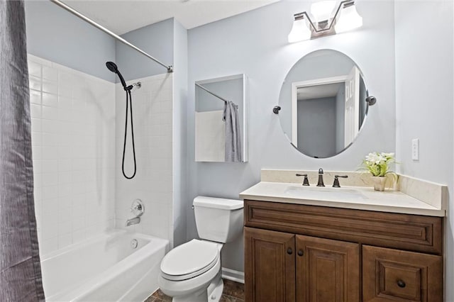 full bathroom with tiled shower / bath, vanity, and toilet