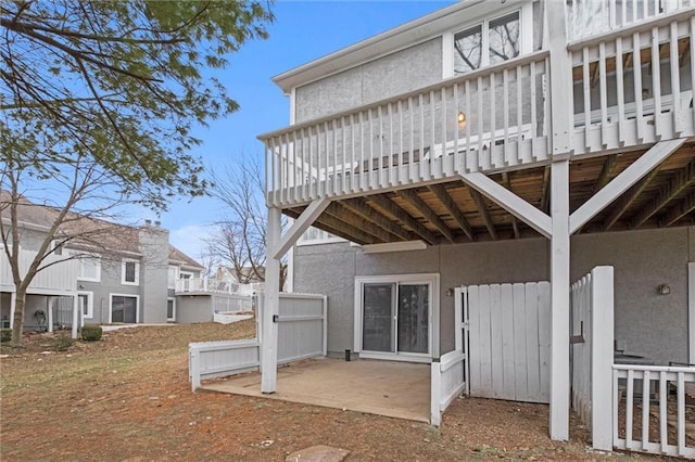 rear view of house featuring a wooden deck