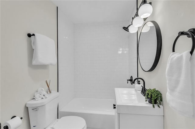 full bathroom with tiled shower / bath combo, vanity, and toilet