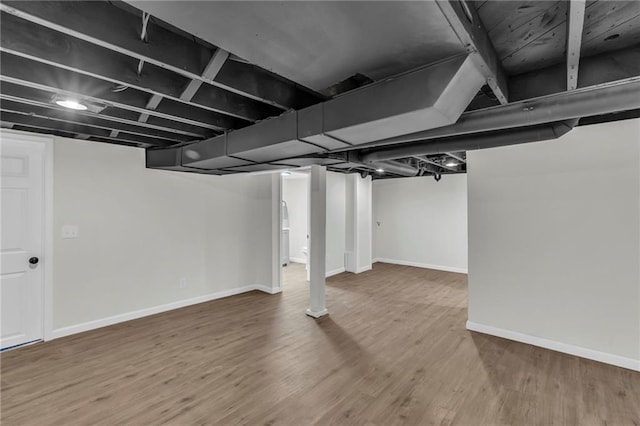 basement with hardwood / wood-style floors