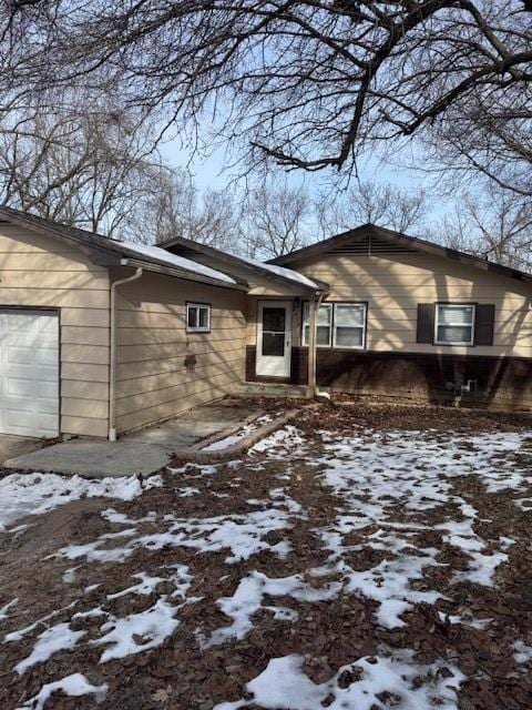 view of snowy exterior with a garage