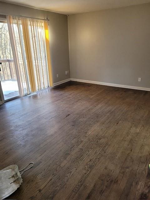 spare room with dark hardwood / wood-style flooring